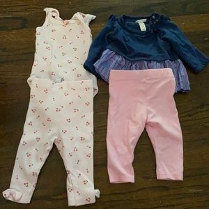 Cherry piece is 3-6 month and the blue outfit is 0-3